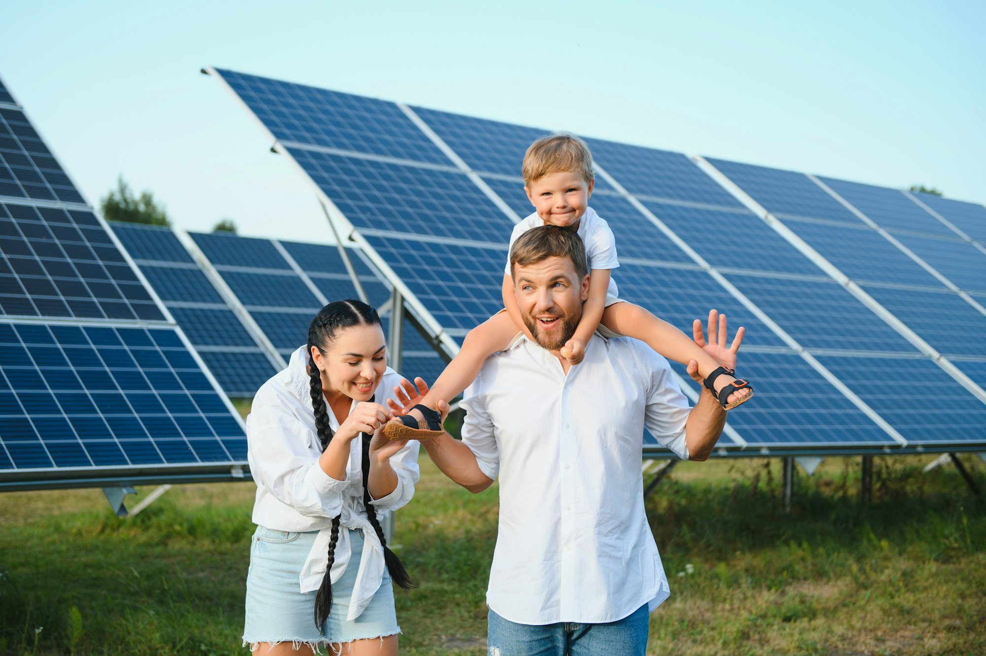 Happy young family near solar panels. Solar energy.